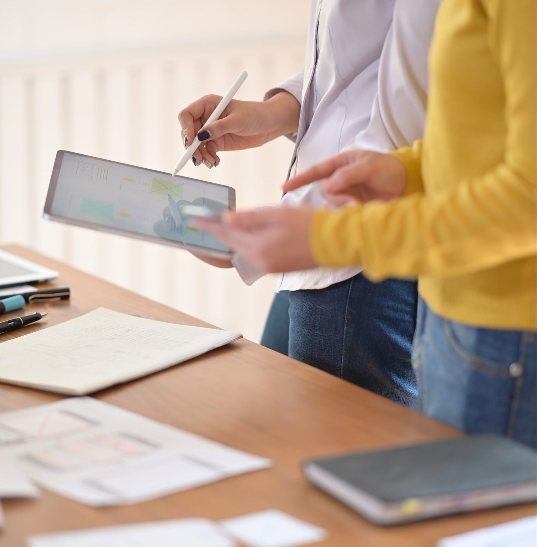 Creative designer planning application with tablet and developing template layout